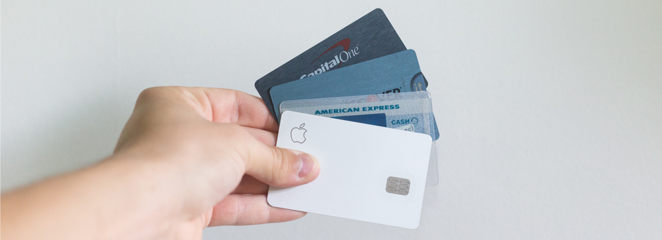 Hand holding multiple credit cards and debit cards for online shopping