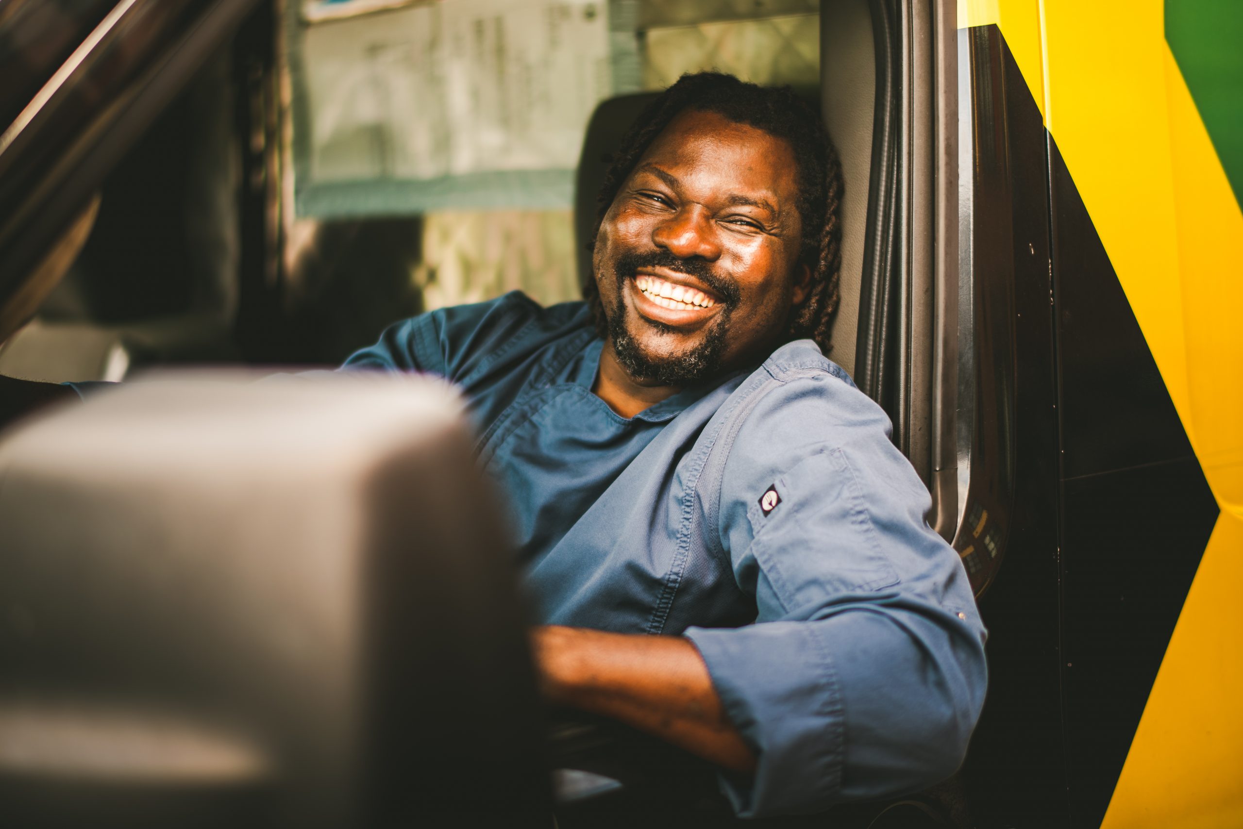 Picture of chef Ernie Campbell driving a truck smiling